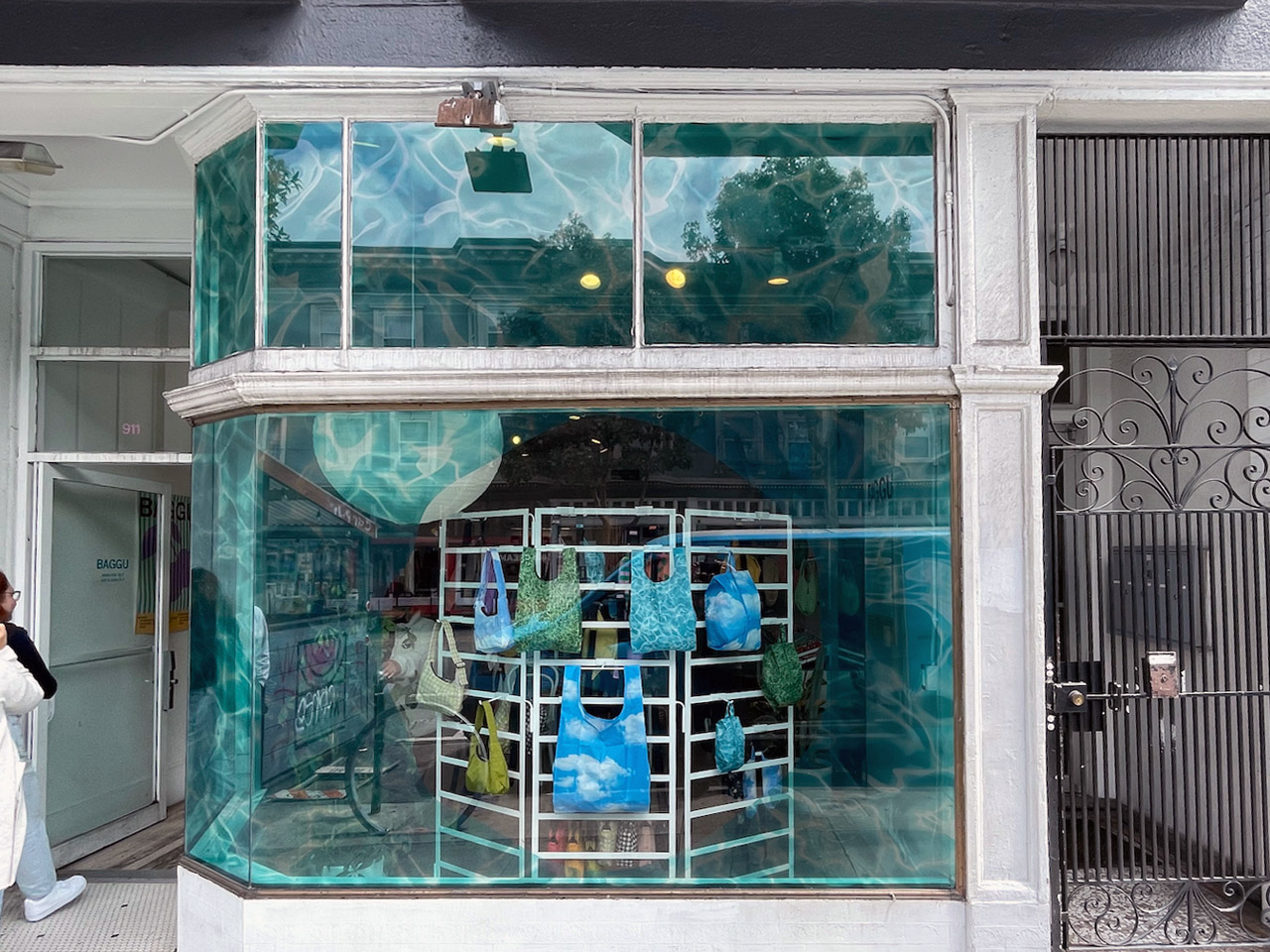 Baggu storefront showcasing custom window coverings installed by Martin Sign Company - a stunning underwater-themed design creating a captivating visual display.